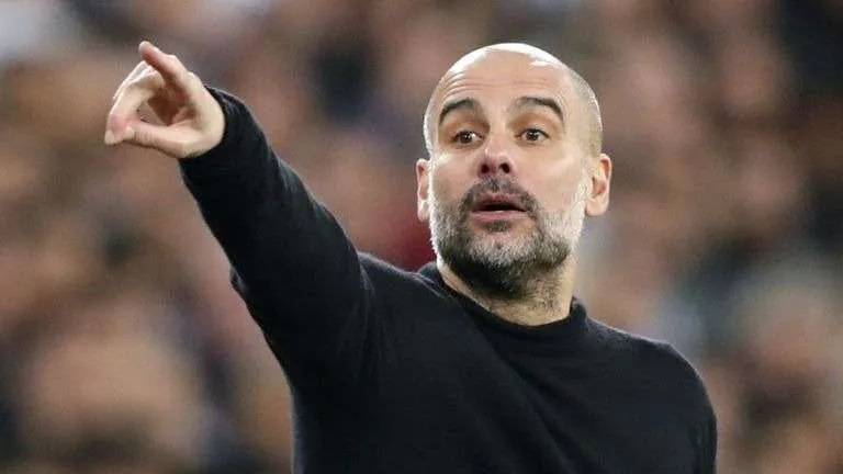 pep guardiola pointing in the air with his finger