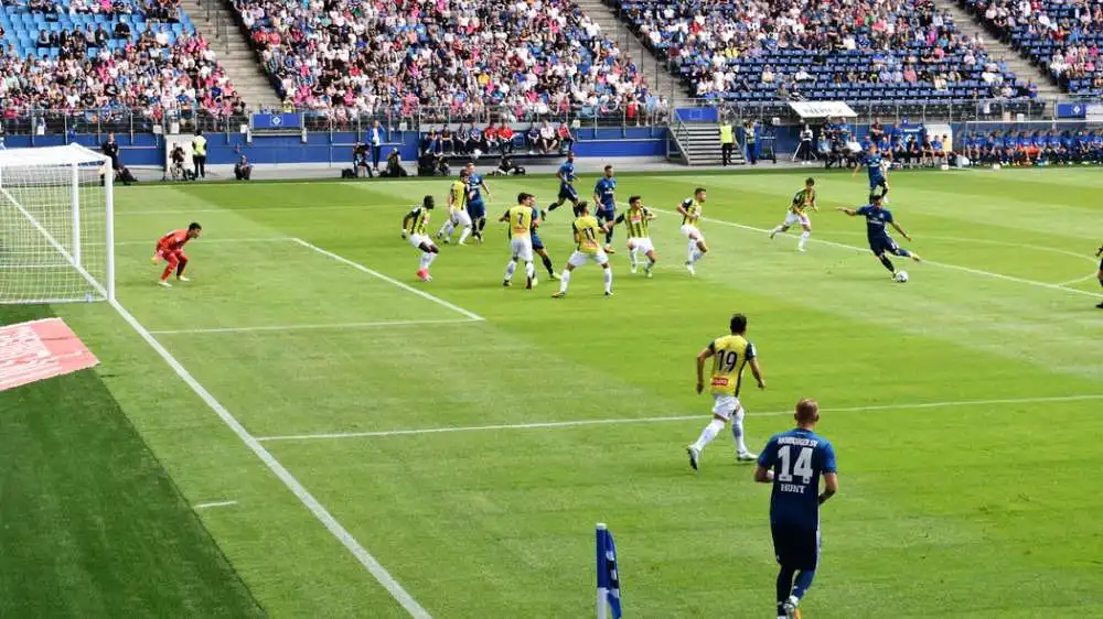 football game between south american clubs one wearing yellow and the other blue