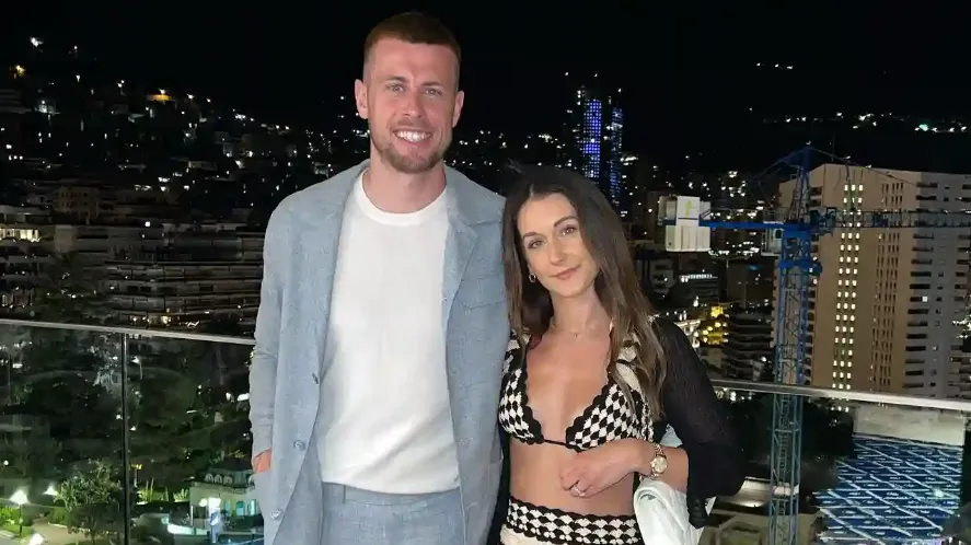 adam webster and melissa webster smiling and posing for a photo at a rooftop of a restaurant