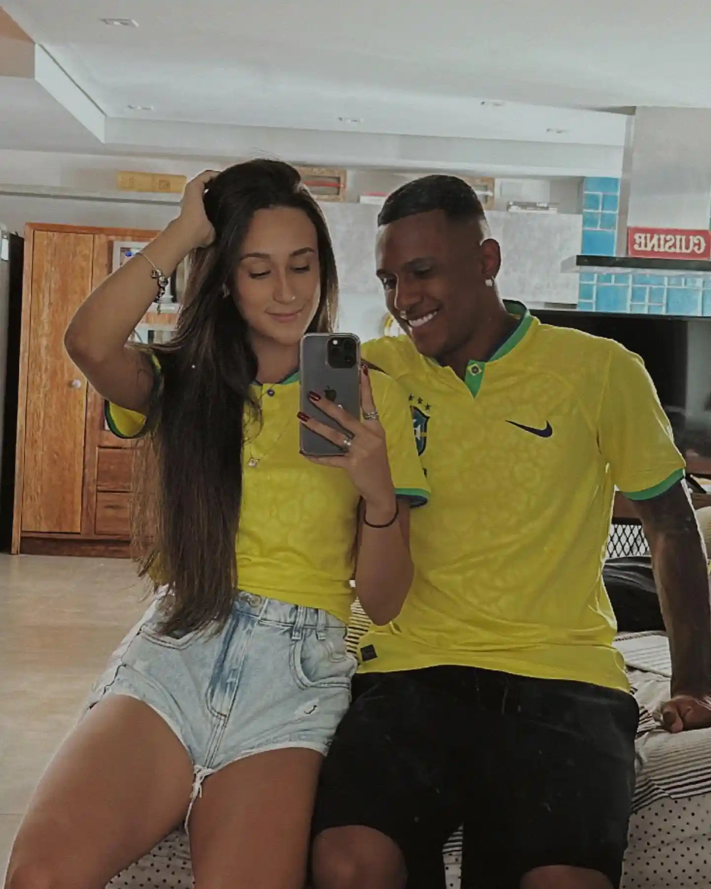 Marquinhos and his girlfriend Beatriz Vinhaes wearing Brazil national team shirts