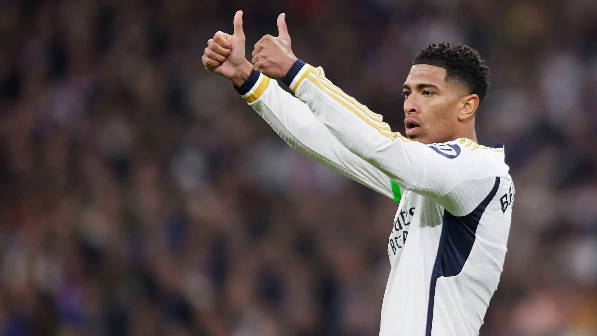 Jude Bellingham gives a double thumbs-up while wearing a Real Madrid kit during a match