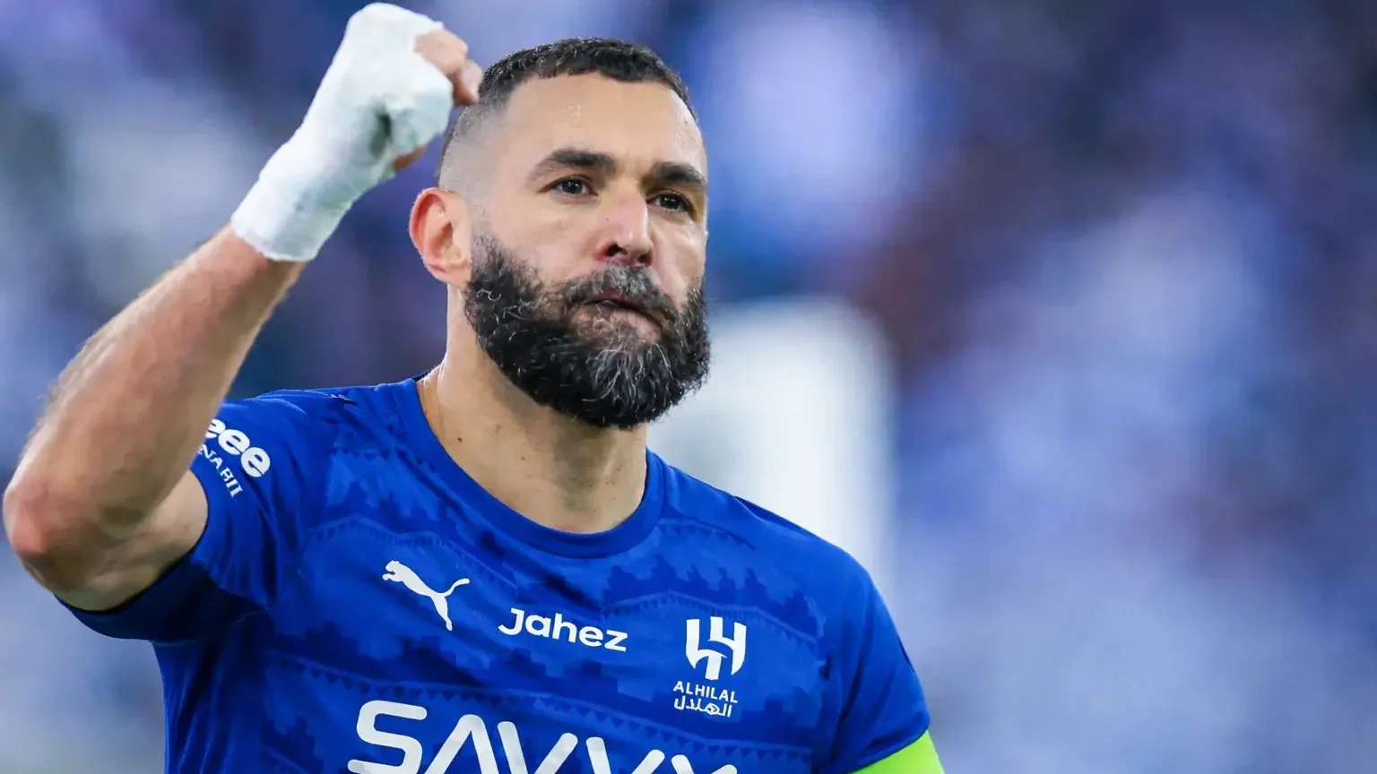 Karim Benzema celebrating in Al Hilal’s blue kit with a raised fist
