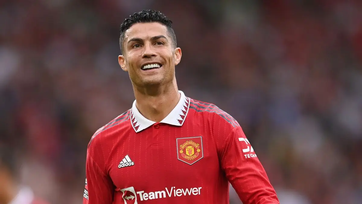 cristiano ronaldo wearing man united shirt and smiling after scoring a goal
