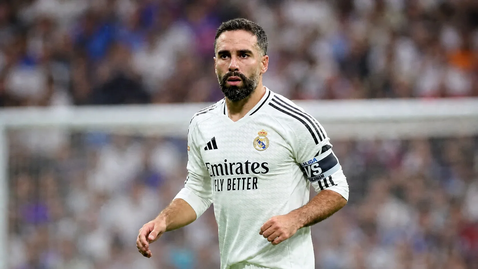 Danny Carvajal in a white Real Madrid kit during a match with a blurred stadium background