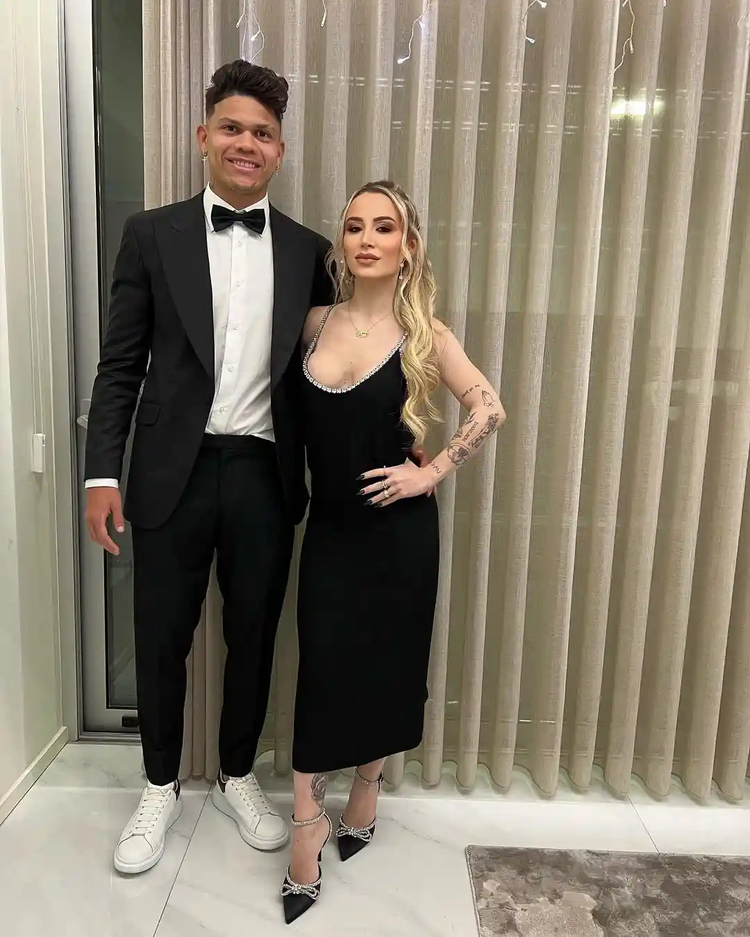 evanilson and mariana wearing black official clothes