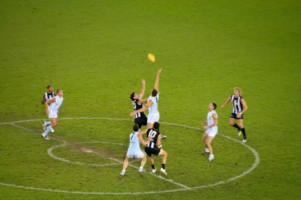 autralian football players jumping for a ball