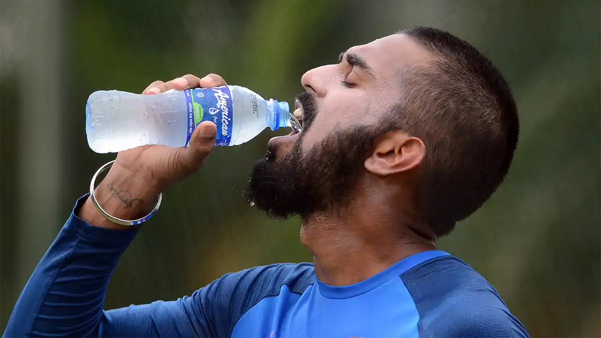 a football player with beard drinking cold water