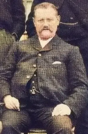 harry bradshaw arsenal manager from 1899 sitting in a chair