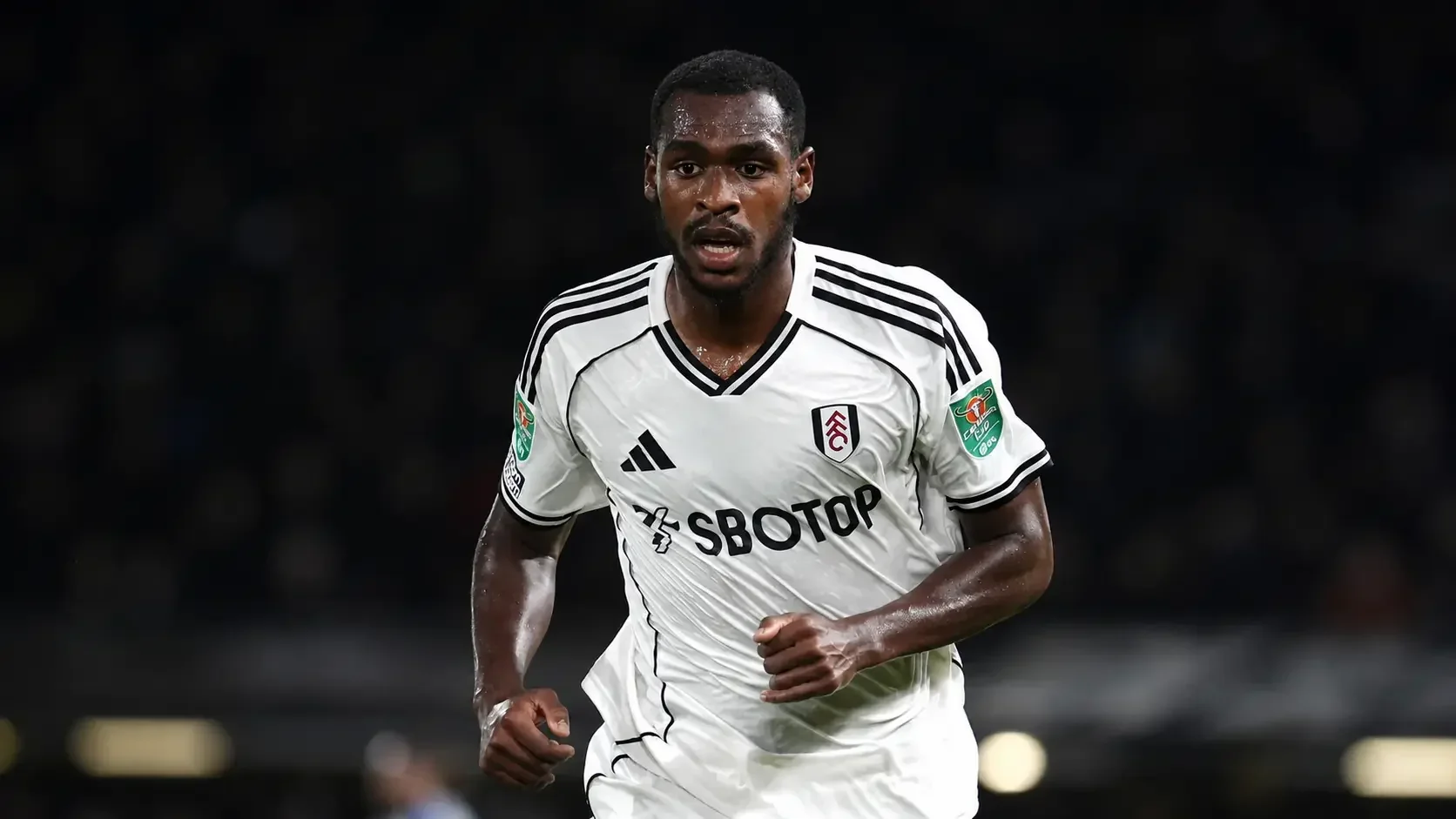 issa Diop running in Fulham’s white kit during a match