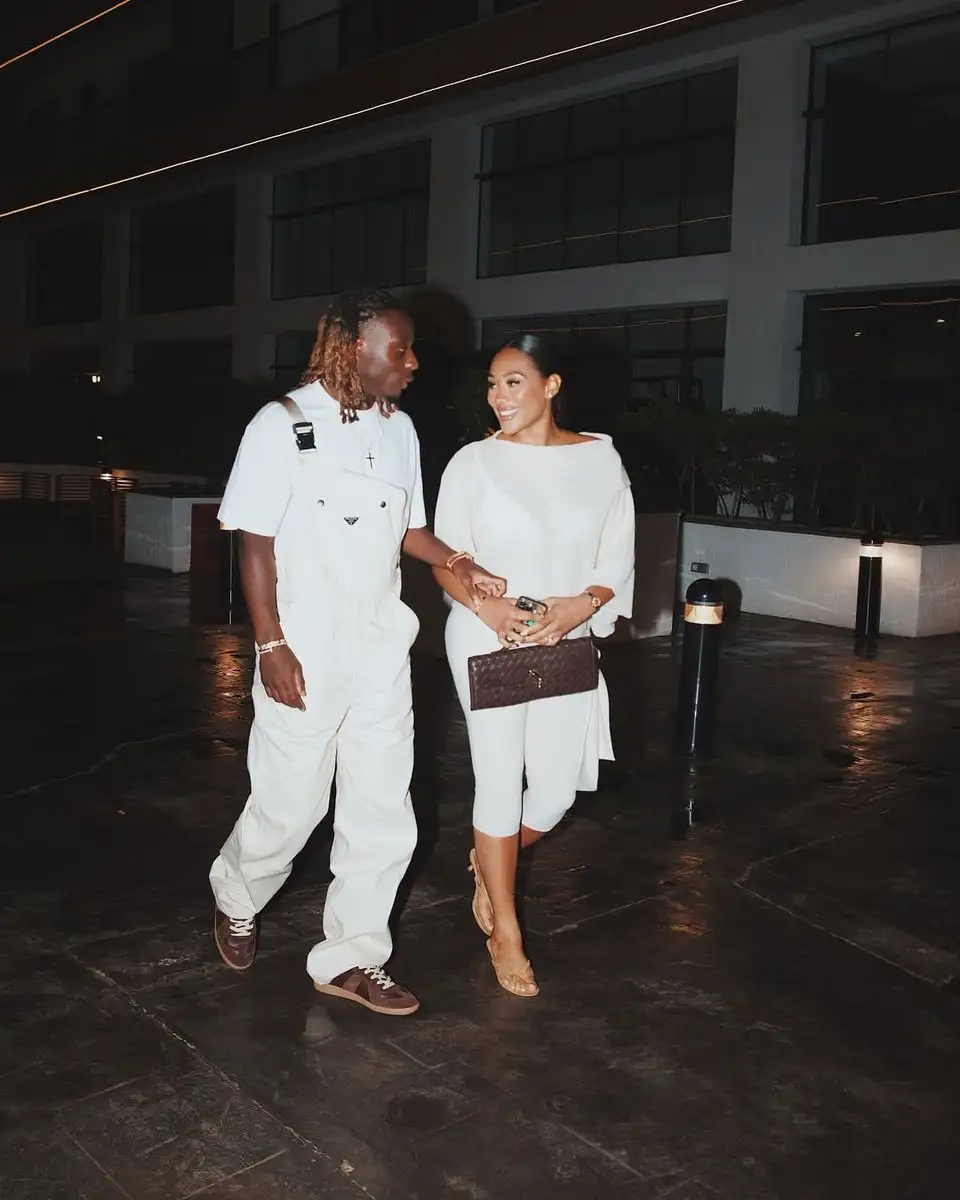 jeremy doku and his fiancee shireen raymond wearing all white