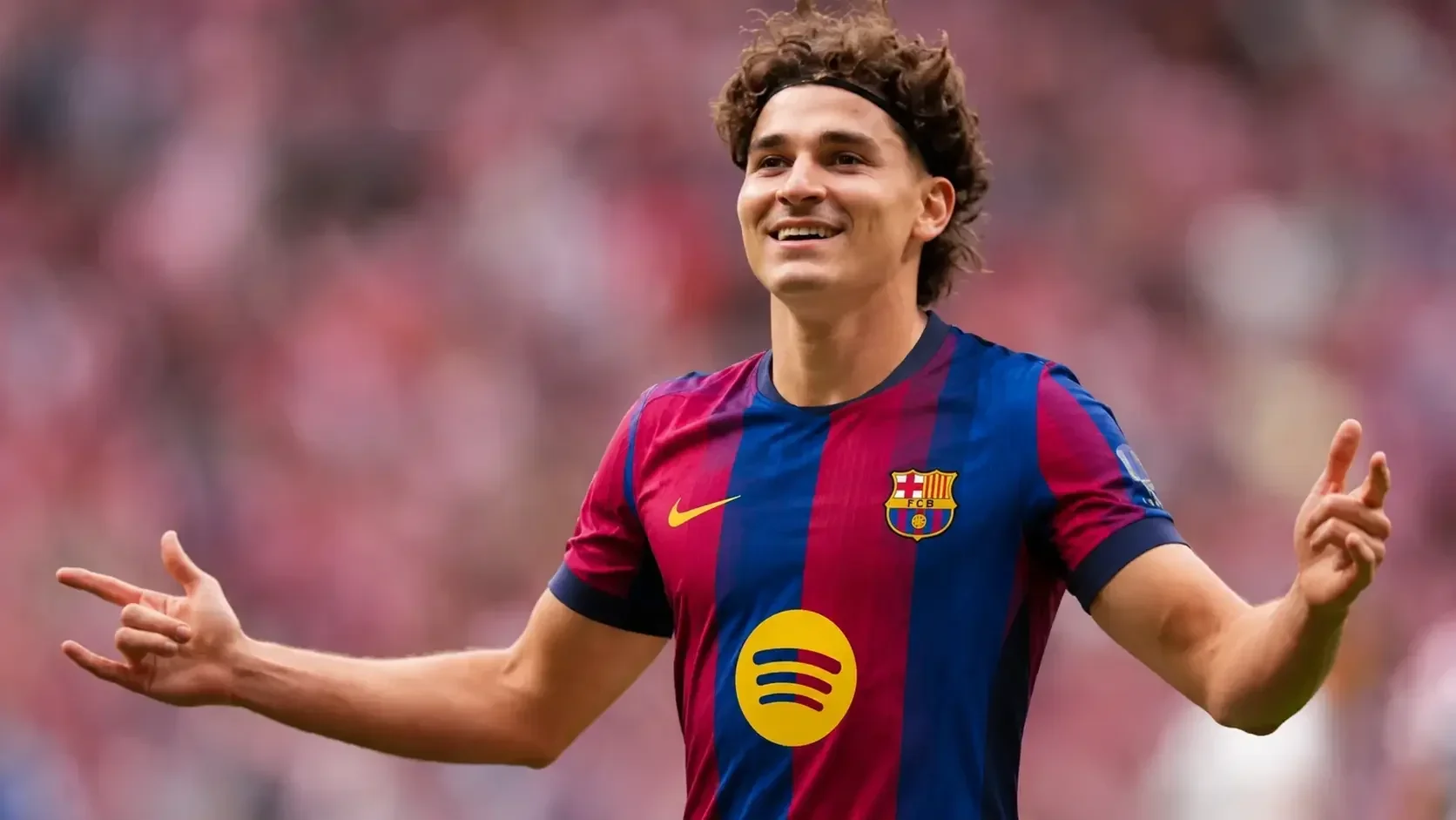 Julian Alvarez wearing a Barcelona kit celebrating on the pitch