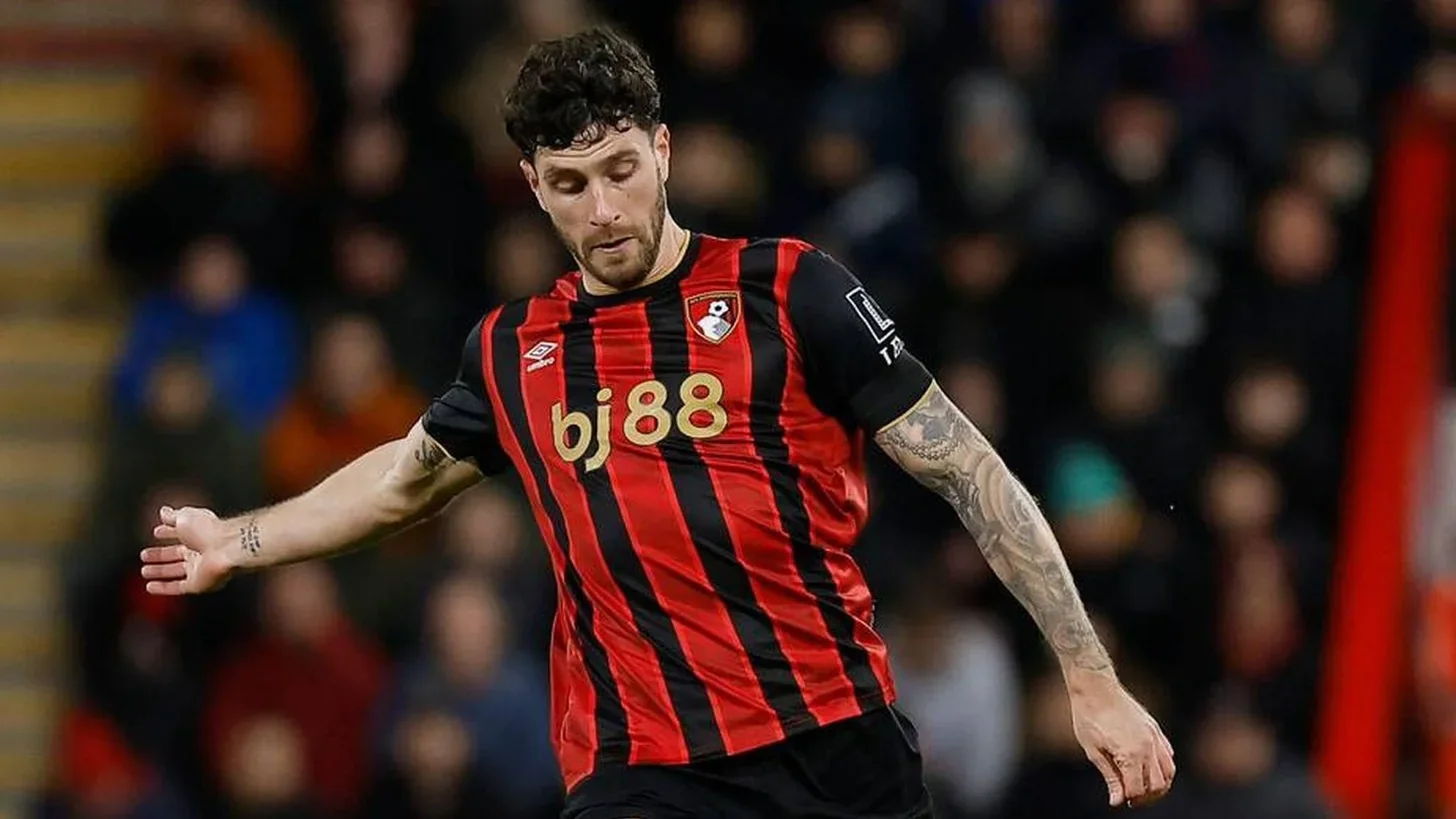 Marcos Senesi in action for Bournemouth, preparing to play a long pass.