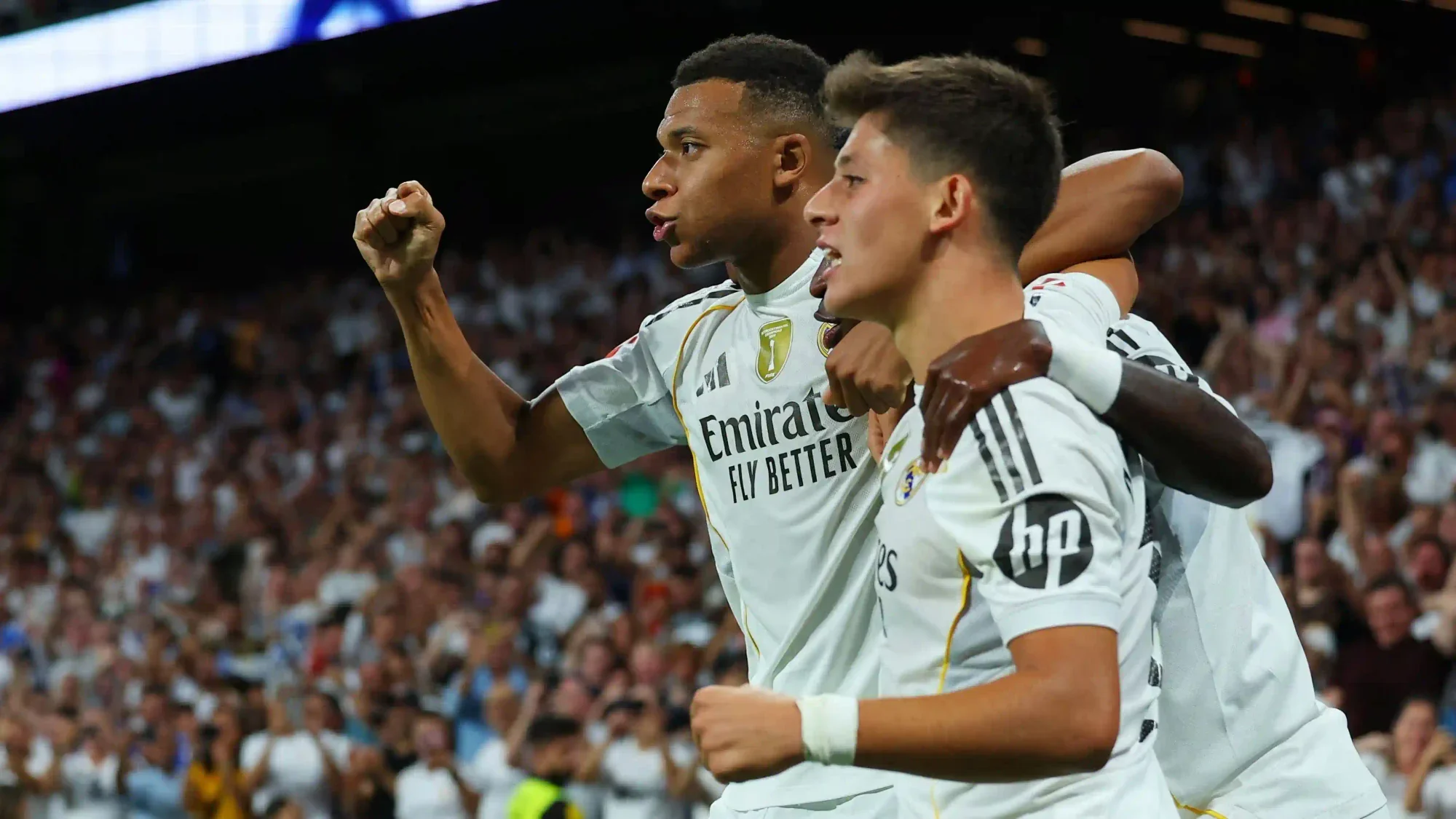 Arda Güler celebrates alongside Kylian Mbappé during a Real Madrid match at the Santiago Bernabéu
