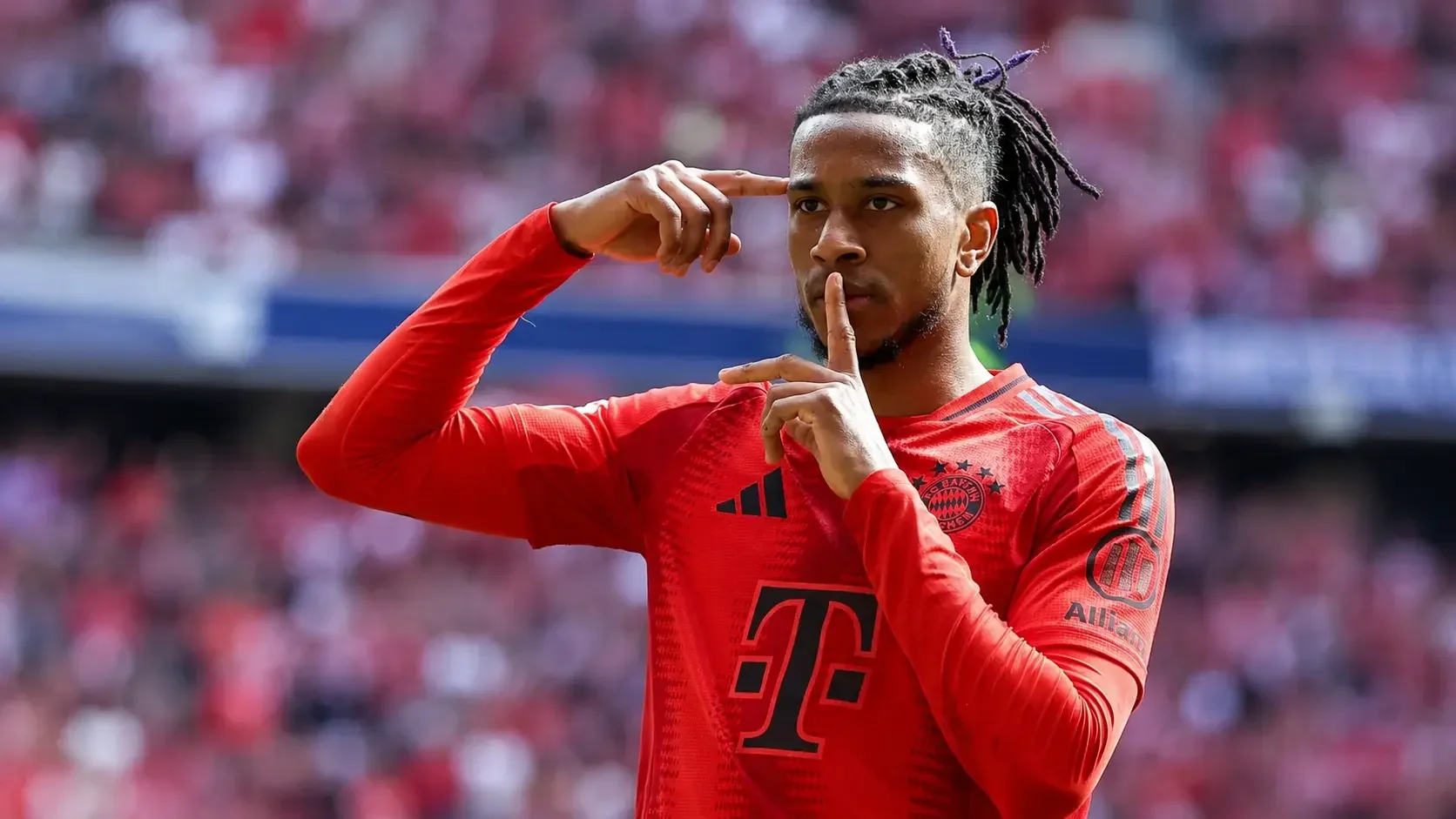 Michael Olise celebrating in Bayern Munich red kit
