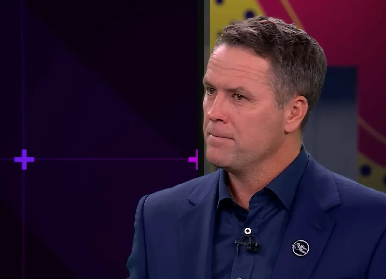 Michael Owen in a studio interview setting, dressed in a navy blazer and shirt.