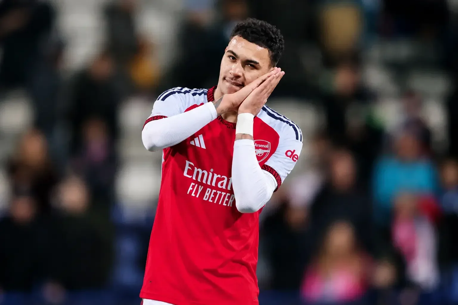 Morgan Rogers wearing an Arsenal kit performing his trademark celebration during a match