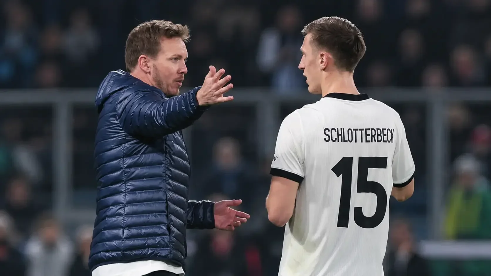 Julian Nagelsmann giving instructions to Nico Schlotterbeck during a Germany match