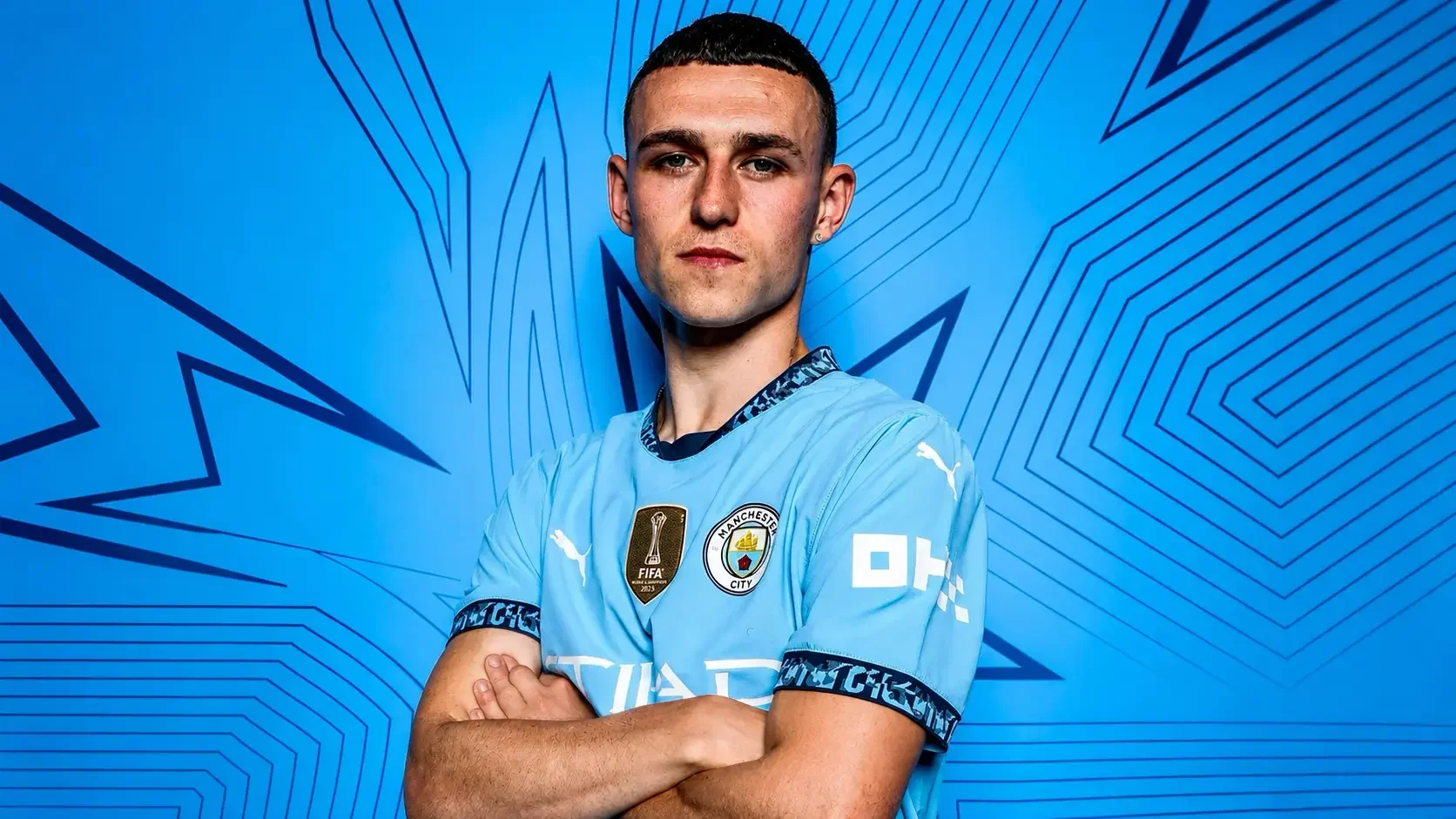 Phil Foden posing in Manchester City’s home kit