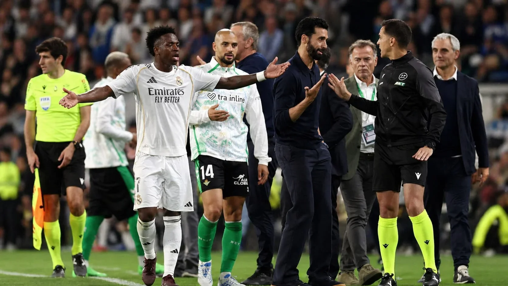 Real Madrid player arguing with officials on the pitch during a heated football match moment