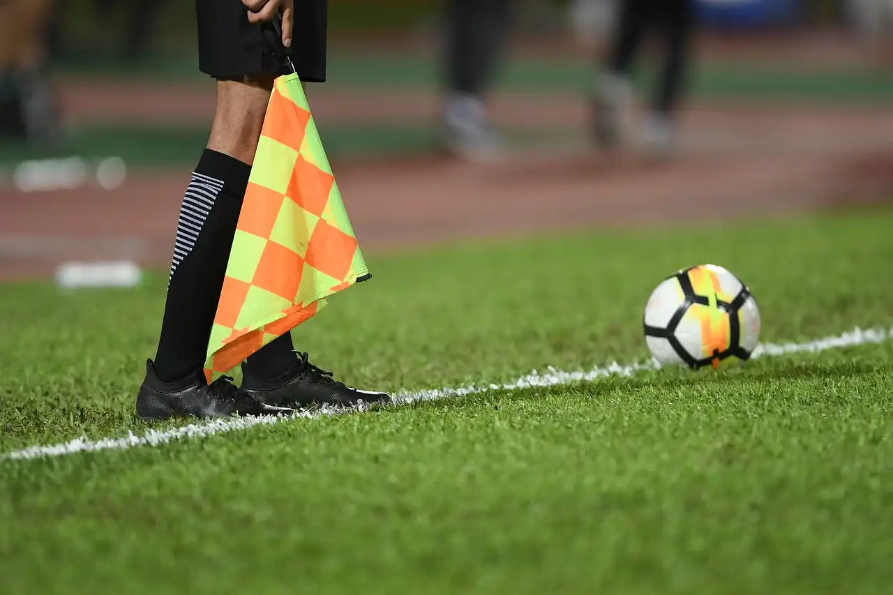 the assistant referee with a ball in front of his flag