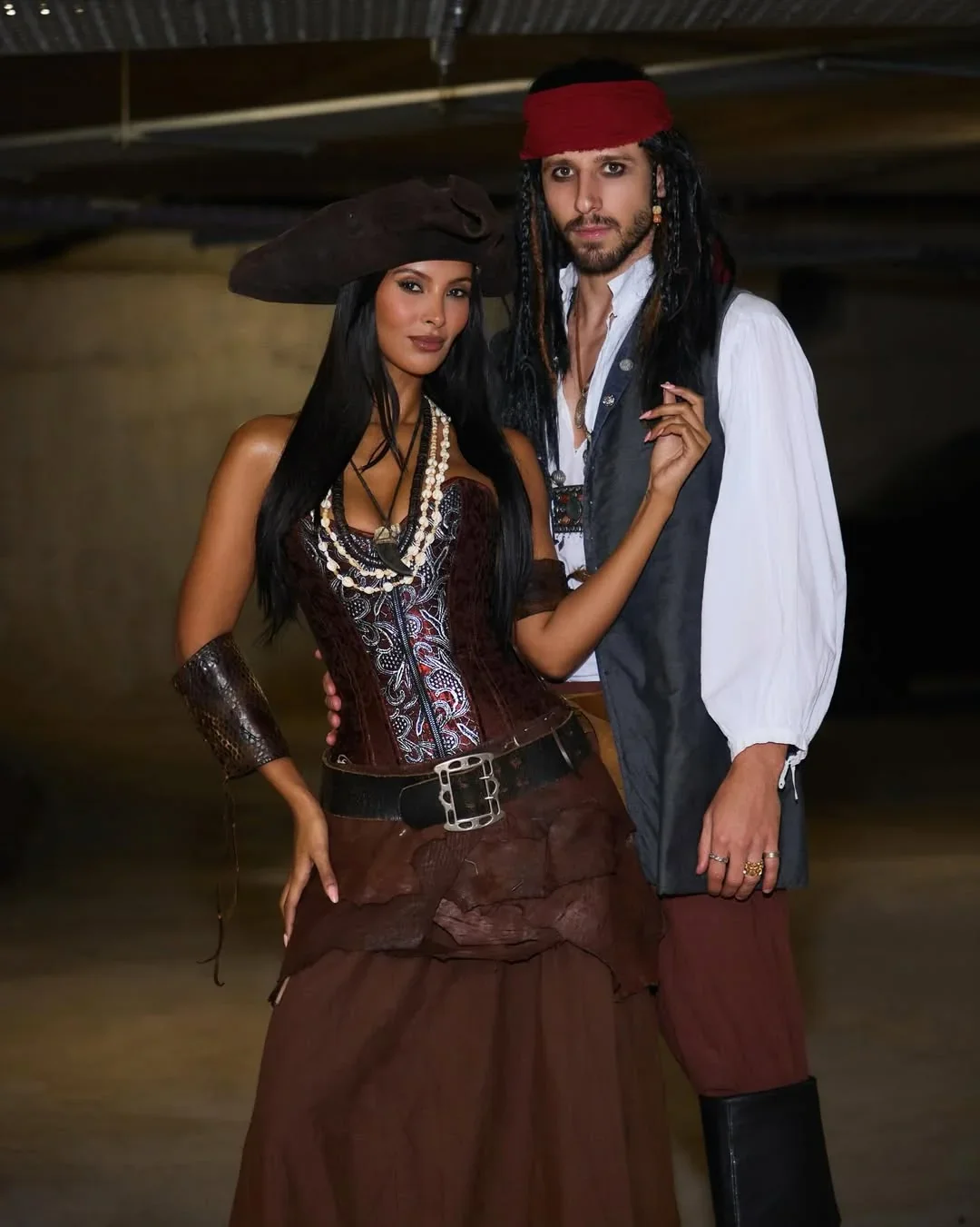 Ruben dias and maya jama dressed in matching pirate costumes posing together at a party