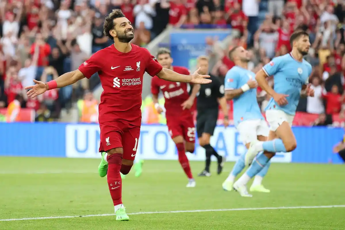 mohamed salah running and smiling after scoring against man city