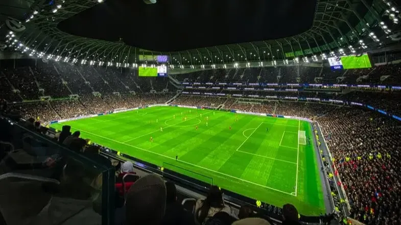 football match played on a stadium wih thousands of fans