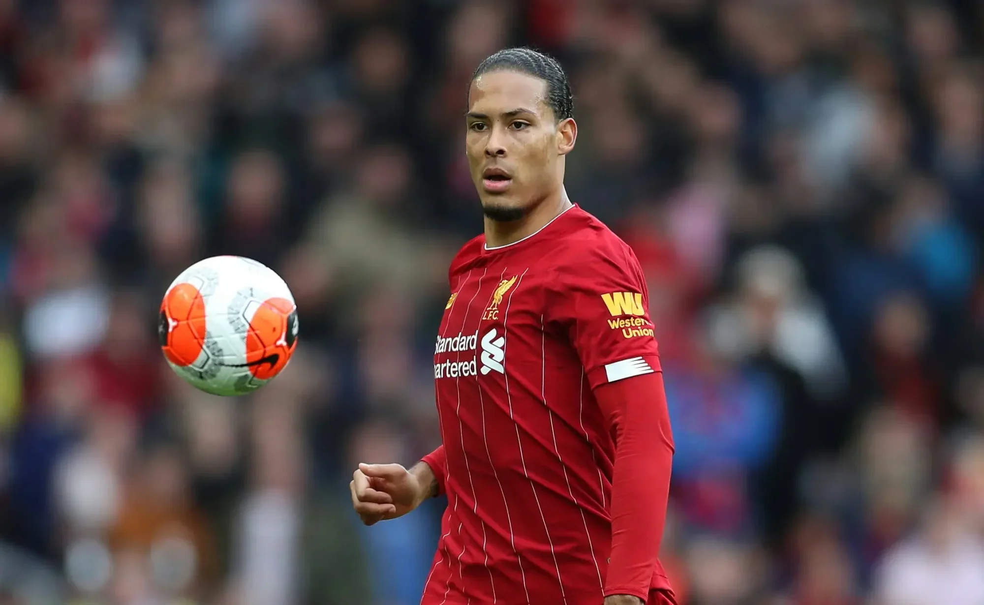 Virgil van Dijk in action for Liverpool during a Premier League match in the red kit