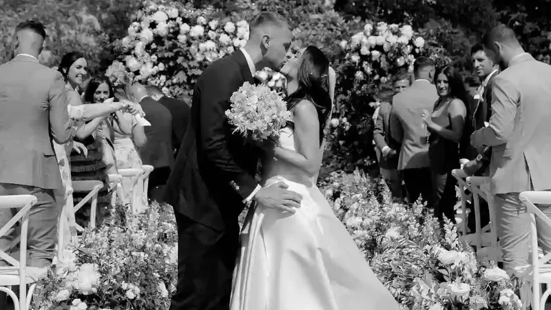 black white photo of adam webster and melissa webster kissing at their wedding